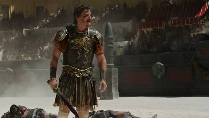 Pedro Pascal stood wearing ancient Roman armour in a colosseum in Gladiator 2.