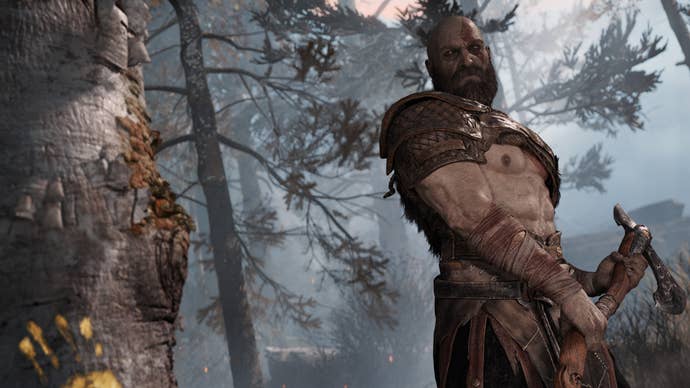 Kratos holding an axe and getting ready to swing it at a tree in the opening cutscene for the 2018 God of War reboot.