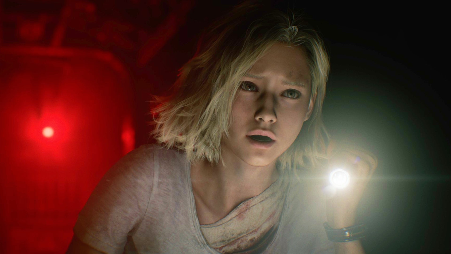 Grace Ashcroft, one of the two protagonists of Resident Evil Requiem, holds up a flashlight with a frightened look on her face.