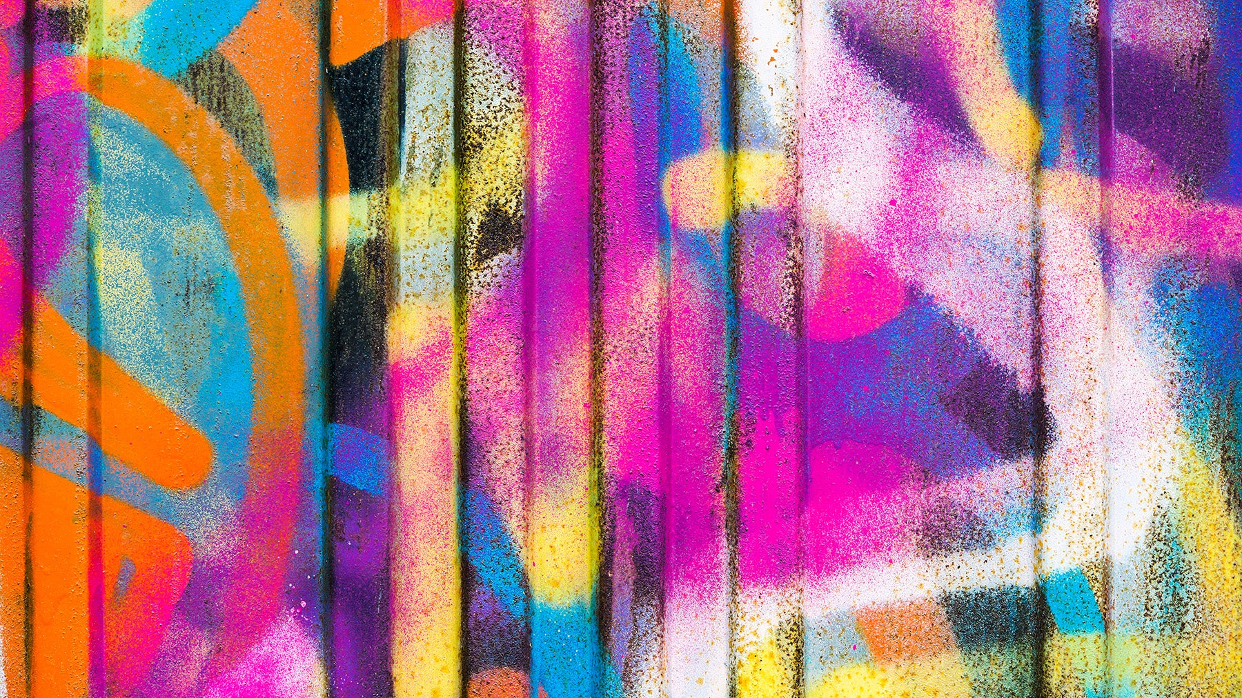 Colourful graffiti sprayed on a wall