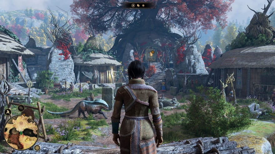 The player looks over a village of huts, where a monster strolls past.