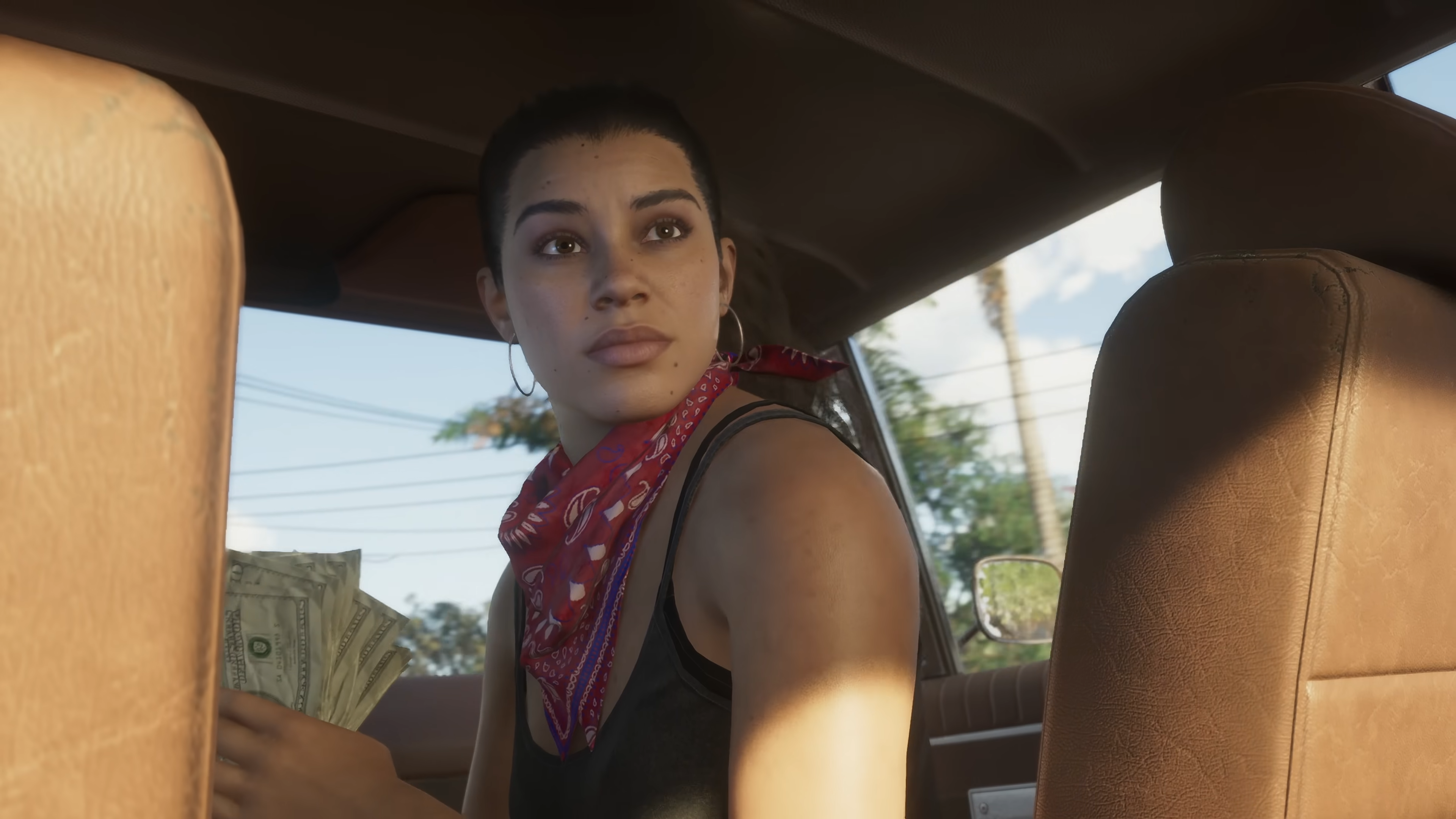 GTA 6 Lucia sitting shotgun in a car looking back out of the rear window holding a bunch of cash in her hand