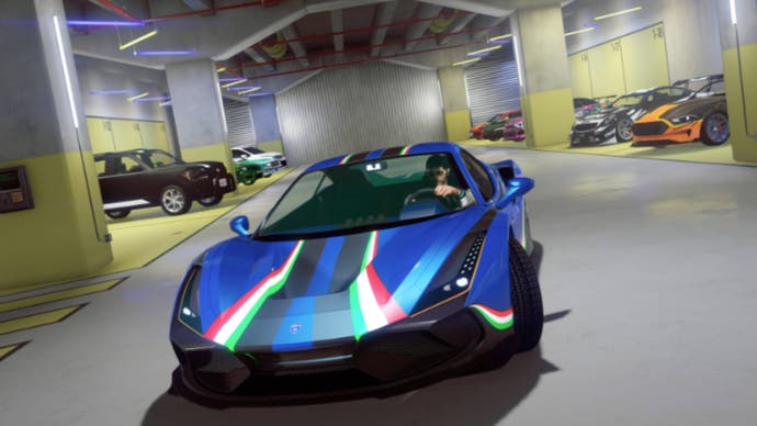 gta online gta+ vinewood club garage with many cars inside and a blue sports car leaving.