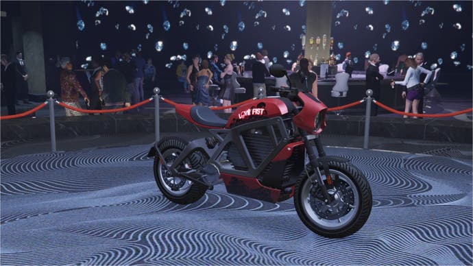 A red love fist themed Western Powersurge motorcycle is parked sideways on the podium in the diamond casino.