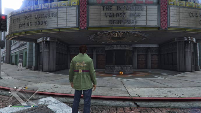 GTA Online, a Jack O'Lantern is sitting outside a theater ticket booth