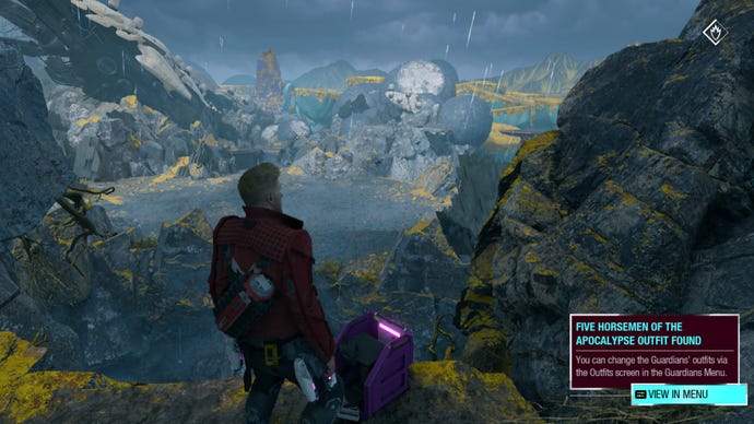 Star-Lord opening an outfit box on a cliff with Seknarf Nine in the background