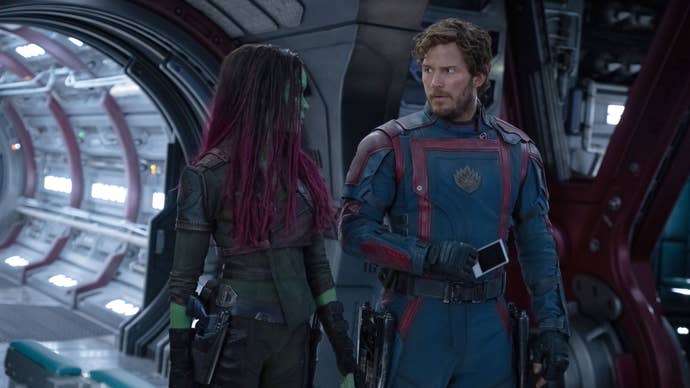 Guardians of the Galaxy Volume 3 still of Gamora and Star-Lord, the latter looking concerned and confused while facing the former.