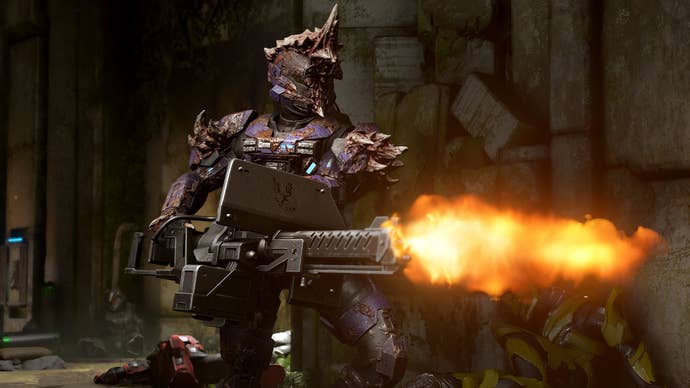 A spartan dressed in goopy Flood armour blasts away with a minigun while dead spartans lay in the background