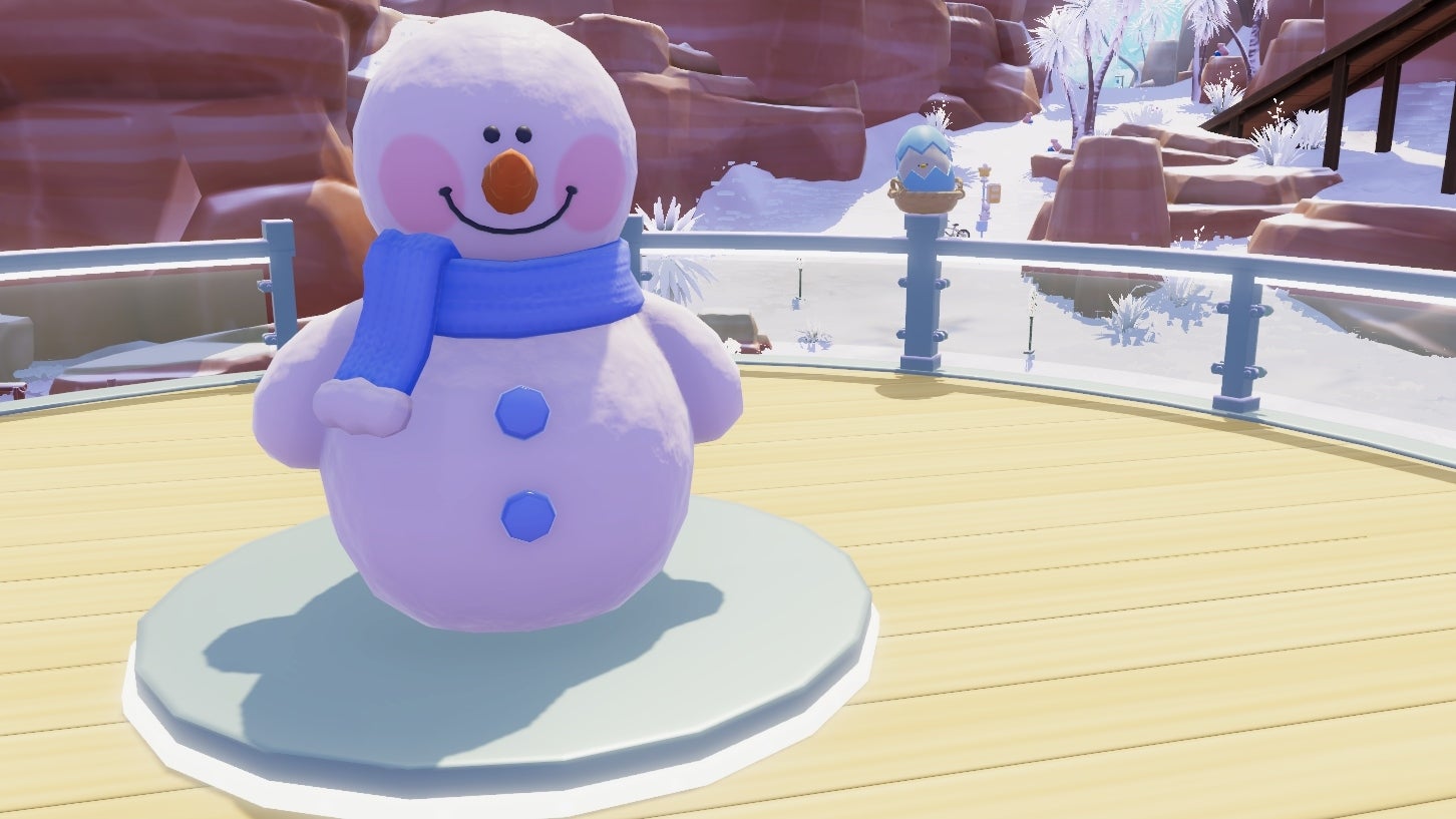 A smiling snowman stands on a wooden rooftop surrounded by glass railings, with an azure egg cracked to show curious peeking eyes just behind it on a fence post. The background is of a reddish mountainous area covered in snow. - 9