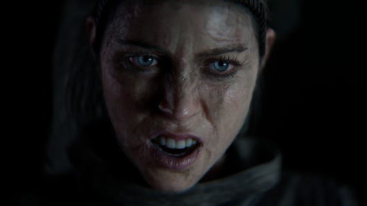 Senua, the heroine of Hellblade 2, looks angrily past the camera