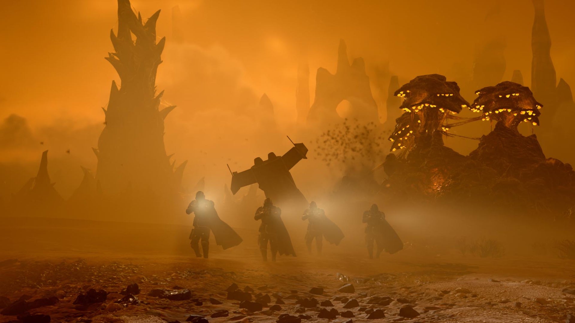 Some Helldivers roaming the surface of a Terminid hive world in Helldivers 2's Into the Unjust Update. - 1
