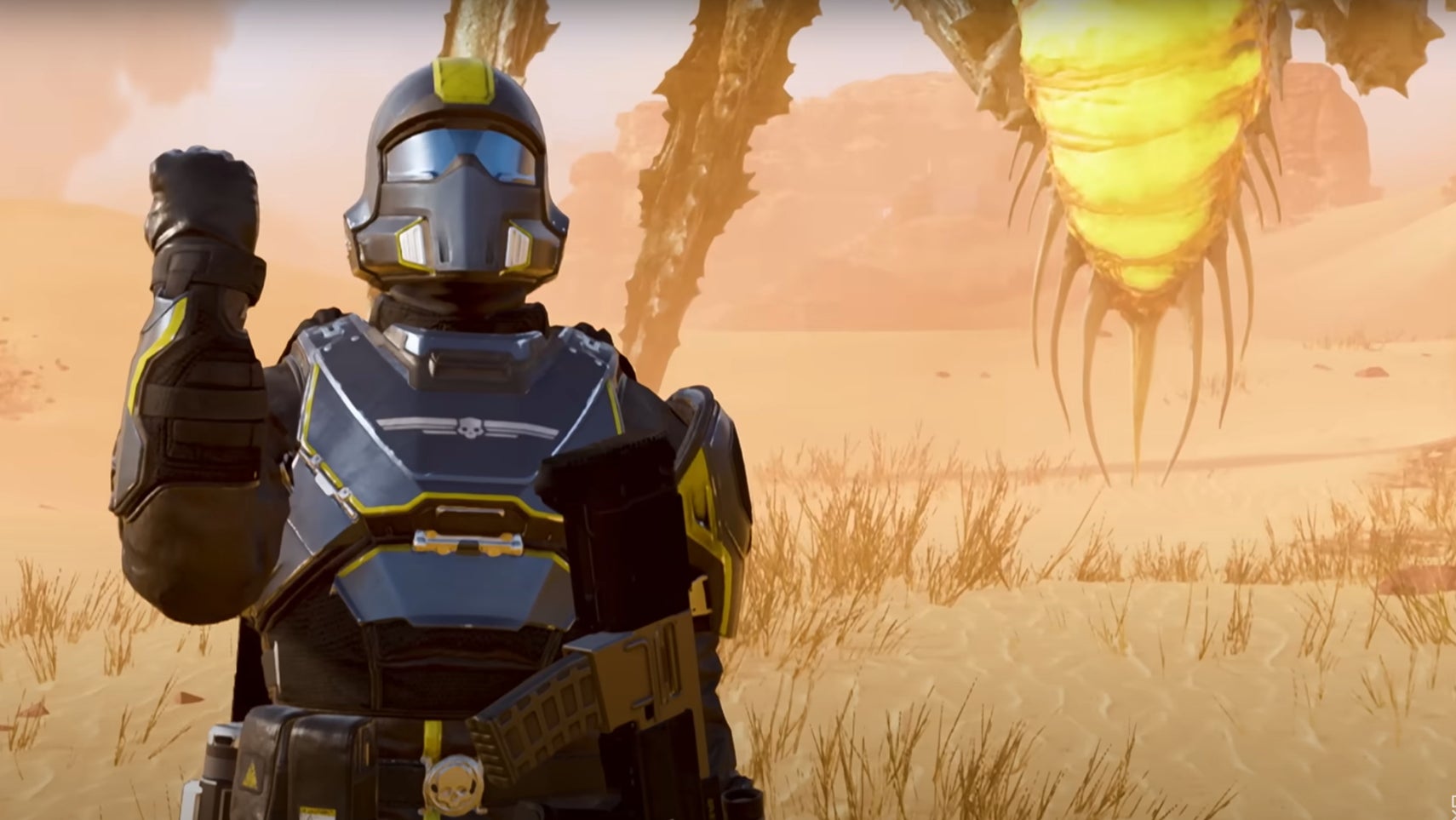 A bile titan standing behind a helldiver in Helldivers 2. - 1