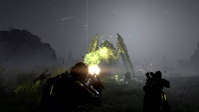 Some soldiers firing on a bug in Helldivers 2.