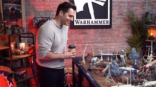 An image Henry Cavill grinning at some Warhammer terrain at Warhammer World