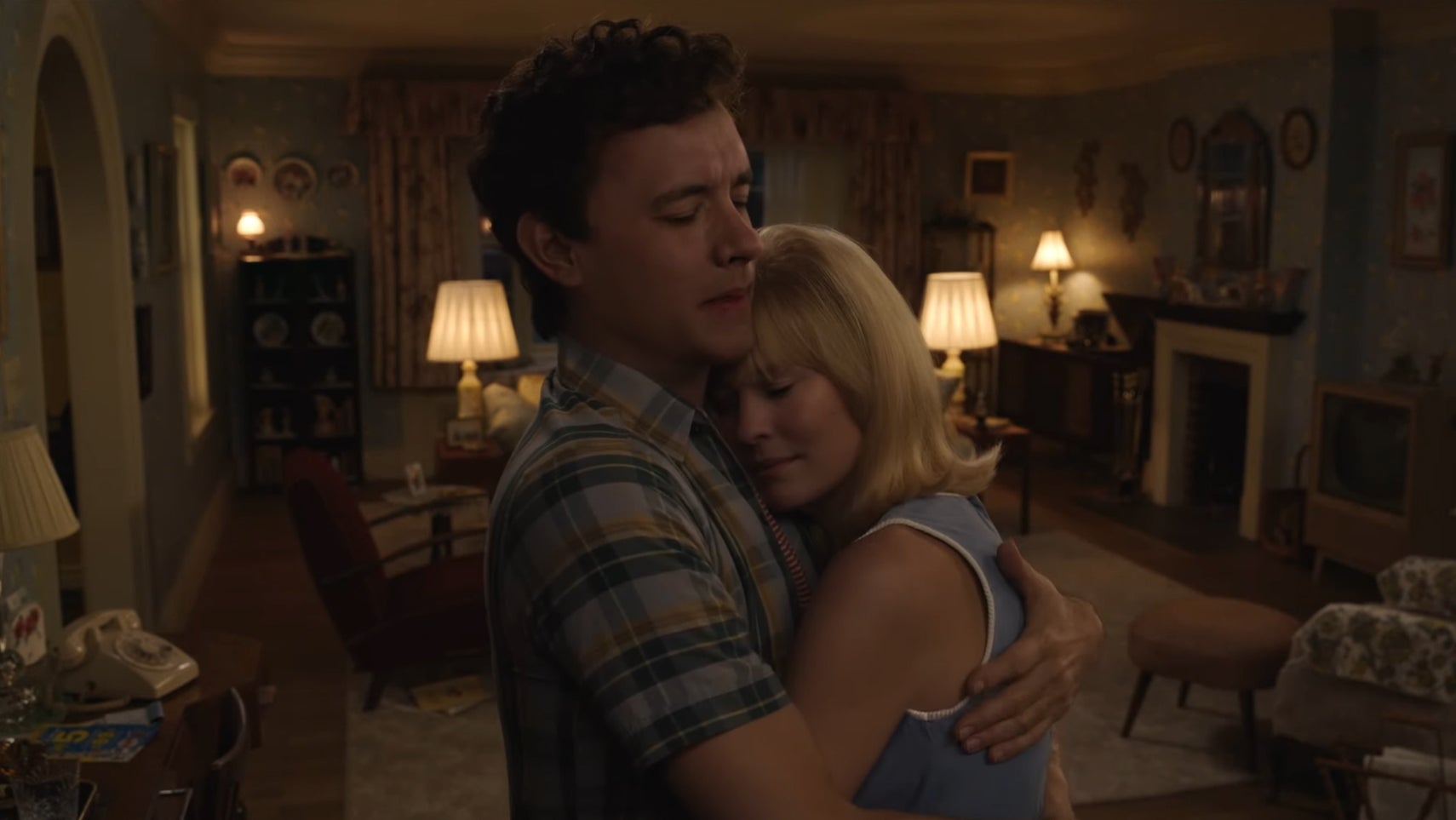 A de-aged Tom Hanks and Robin Wright holding eachother in a living room from Here (2024). - 1