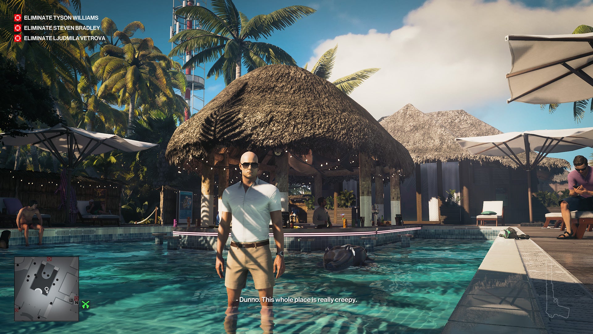 Ian Hitman stands in a pool in front of a swanky pool bar. He&rsquo;s wearing shorts and a white shirt, and looks like he might be on a normal holiday, almost.