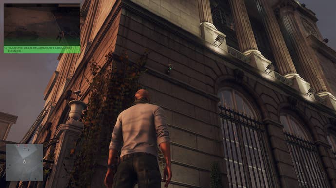 Agent 47 looks up astatine 2 information cameras connected the broadside of a large, opulent building.