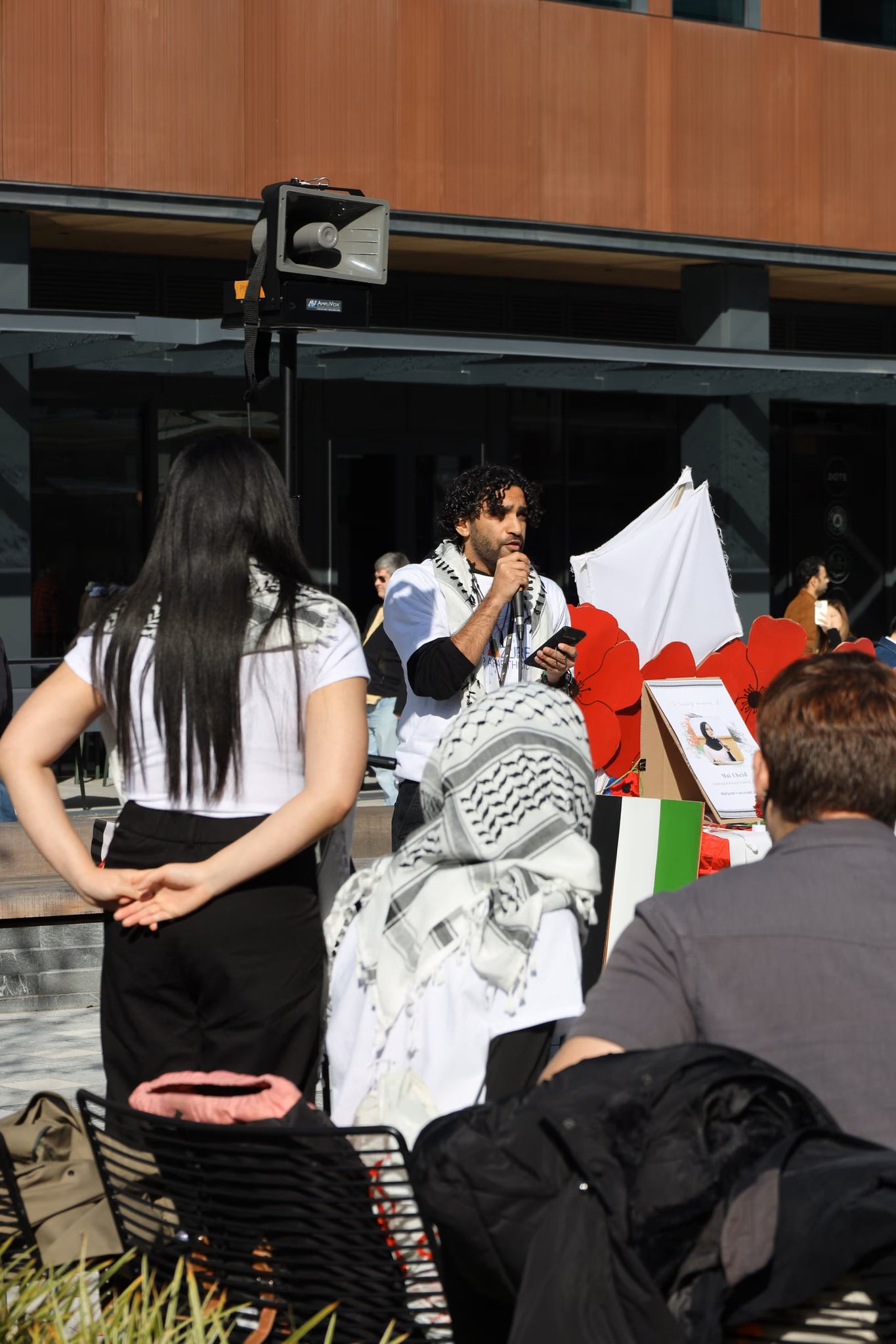 A photograph of former Microsoft employee Hosam Nasr speaking at a vigil for Palestinians killed by Israel at Microsoft's HQ in Redmond on 24th October 2024. - 3