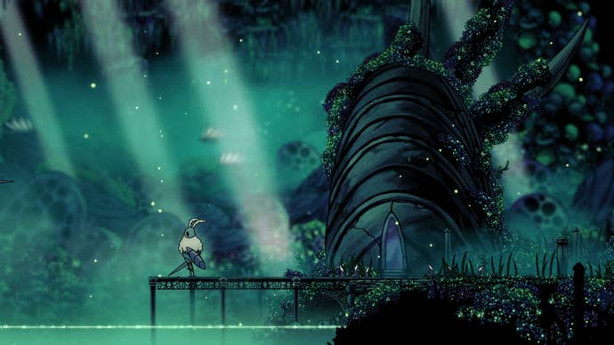 Hollow Knight screenshot showing you at the edge of a jetty over an emerald green, subterranean body of water, with light streaming from above