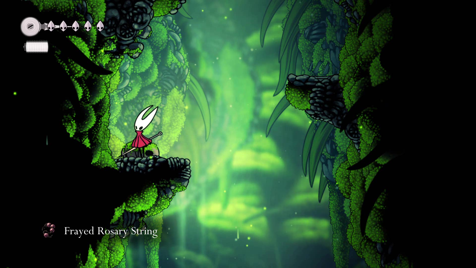 Screenshot of Hollow Knight: Silksong showing the path through the cave of Moss.