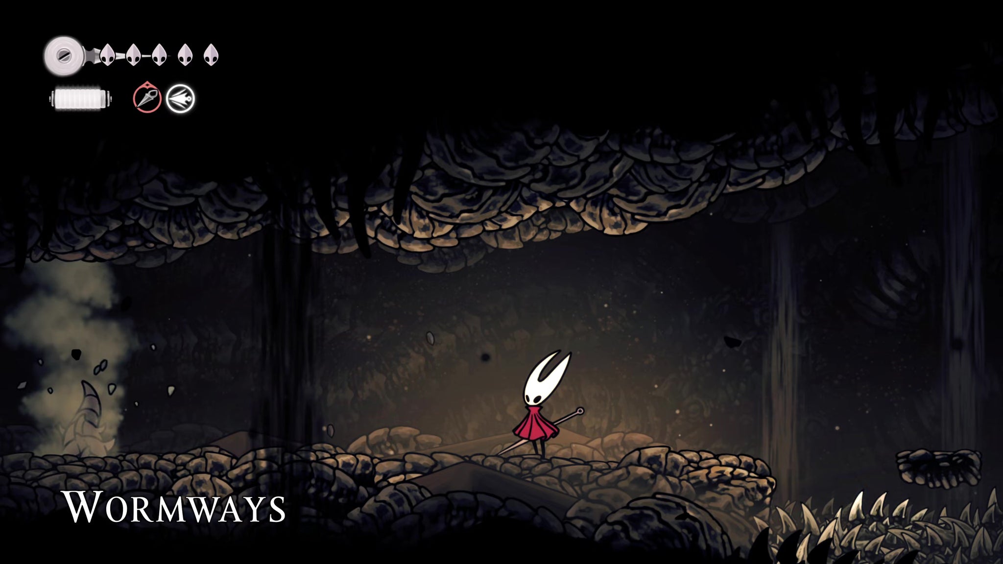 A screenshot of Hollow Knight: Silksong showing the path through to the Chapel Of The Wanderer. - 16
