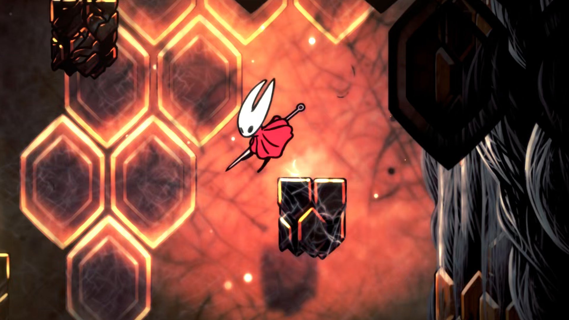 Hornet in Hollow Knight: Silksong dives down a tunnel in the Red Memory section of Act 3, against a backdrop of glowing orange hexagonal lights. - 1