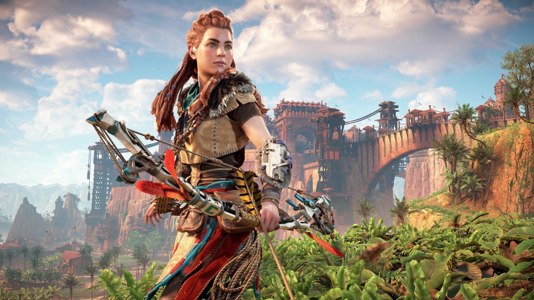Aloy in Horizon Zero Dawn Remastered, she's stood holding her bow and arrow, a bridge and town seen in the background. - 1