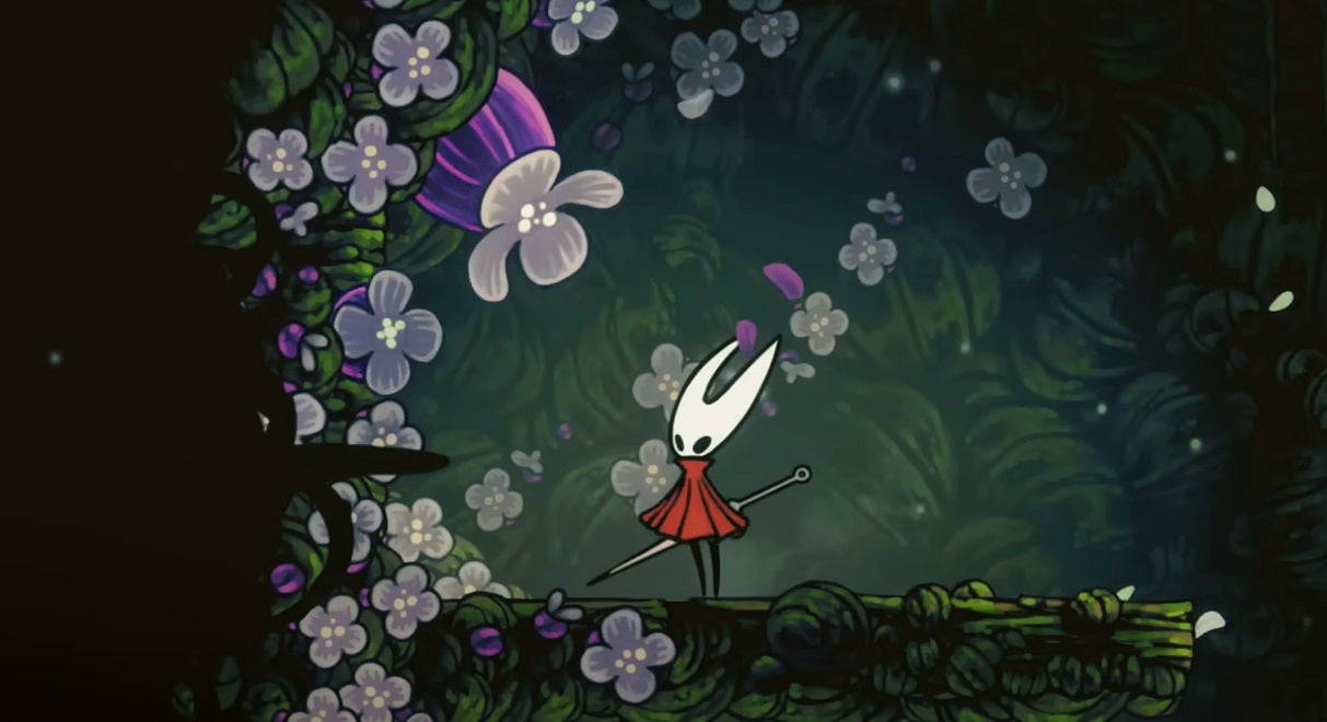 Hornet stands next to a purple flower that contains a Pollip Heart, in Hollow Knight: Silksong. - 1
