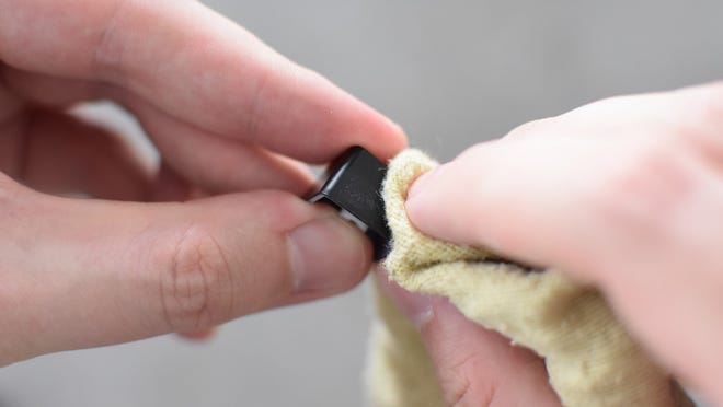 A keyboard keycap being cleaned.