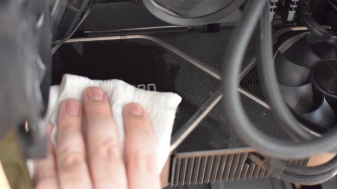 An image of a graphics card being cleaned of dust.