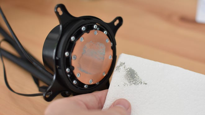 An image of a CPU cooler contact plate, partially cleaned of thermal paste.