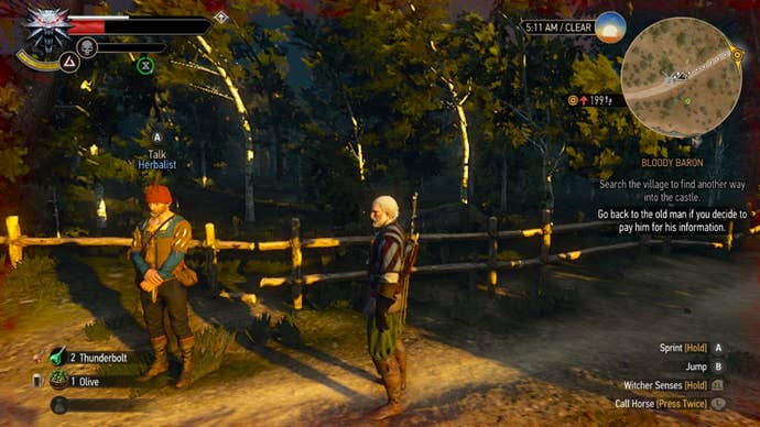 Witcher 3 alchemy: A man in a red and grey striped shirt is standing on a dirt road near a fence, on the edge of a forest. He’s looking at a man wearing a red cap