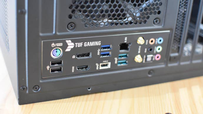 A motherboard’s rear I/O panel, with integrated RF shield, viewed from the back of the PC case.