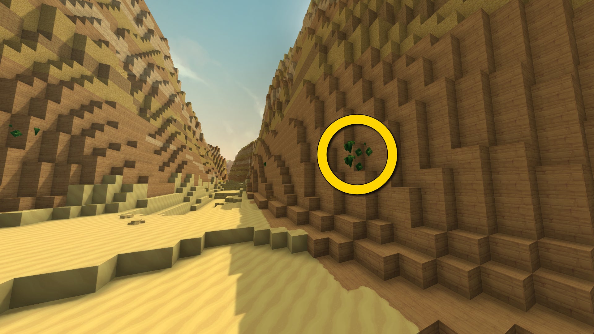 A hilly badlands landscape in Hytale, with a patch of Thorium Ore halfway up the right-hand hill marked with a yellow circle. - 4