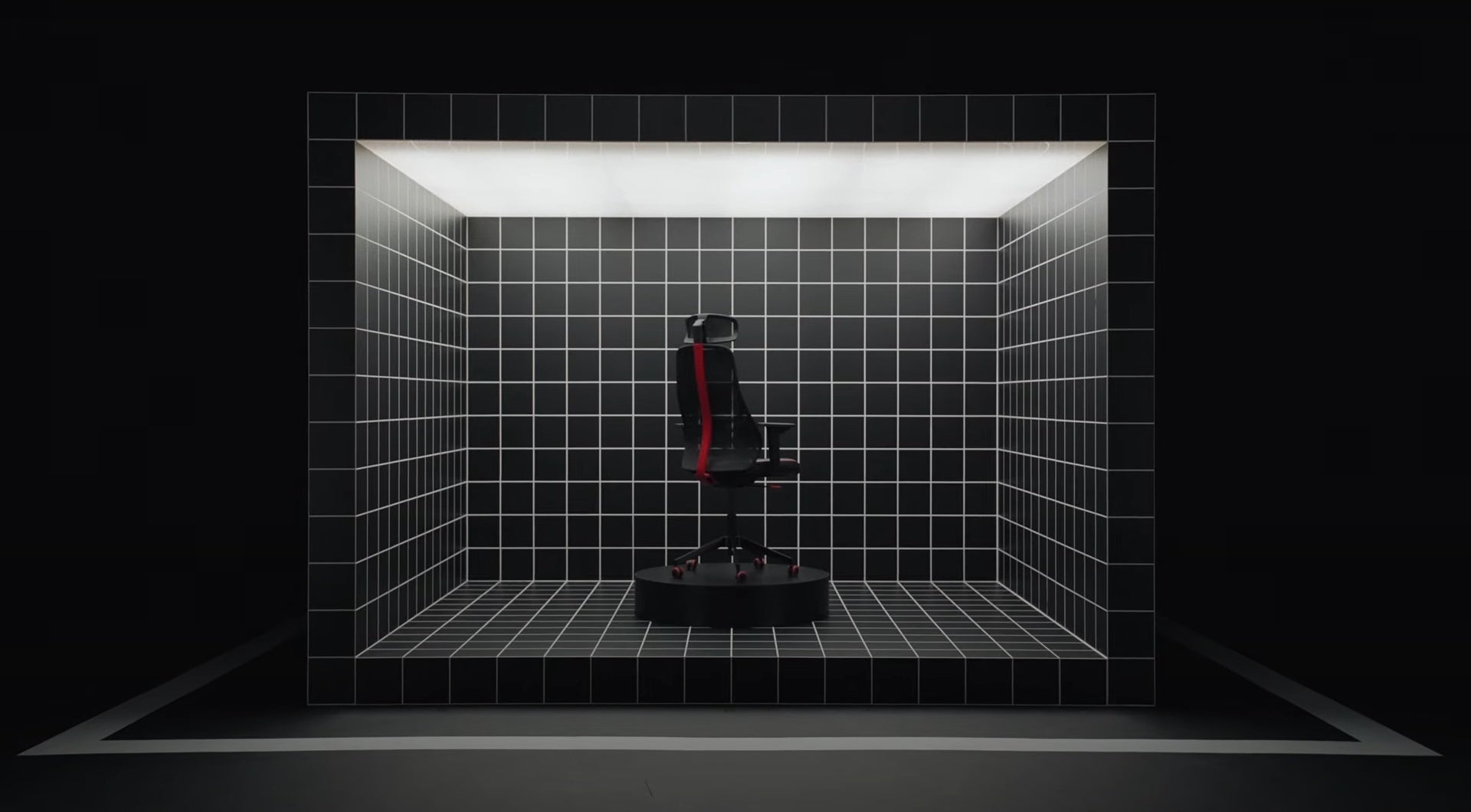 A still from Ikea&rsquo;s video introducing their range of gaming furniture, showing a gaming chair sat inside a cube covered in grid lines.