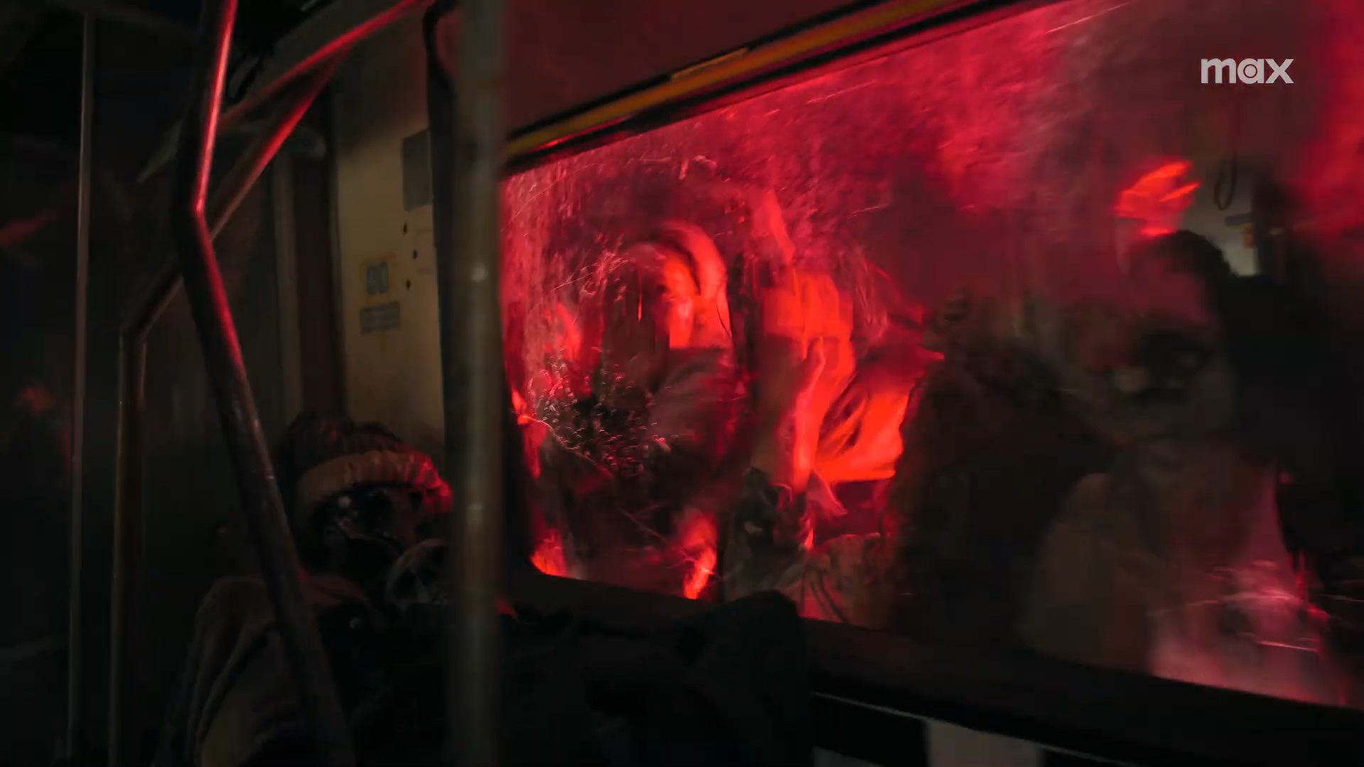 Ellie and Dina in a train car being attacked by infected