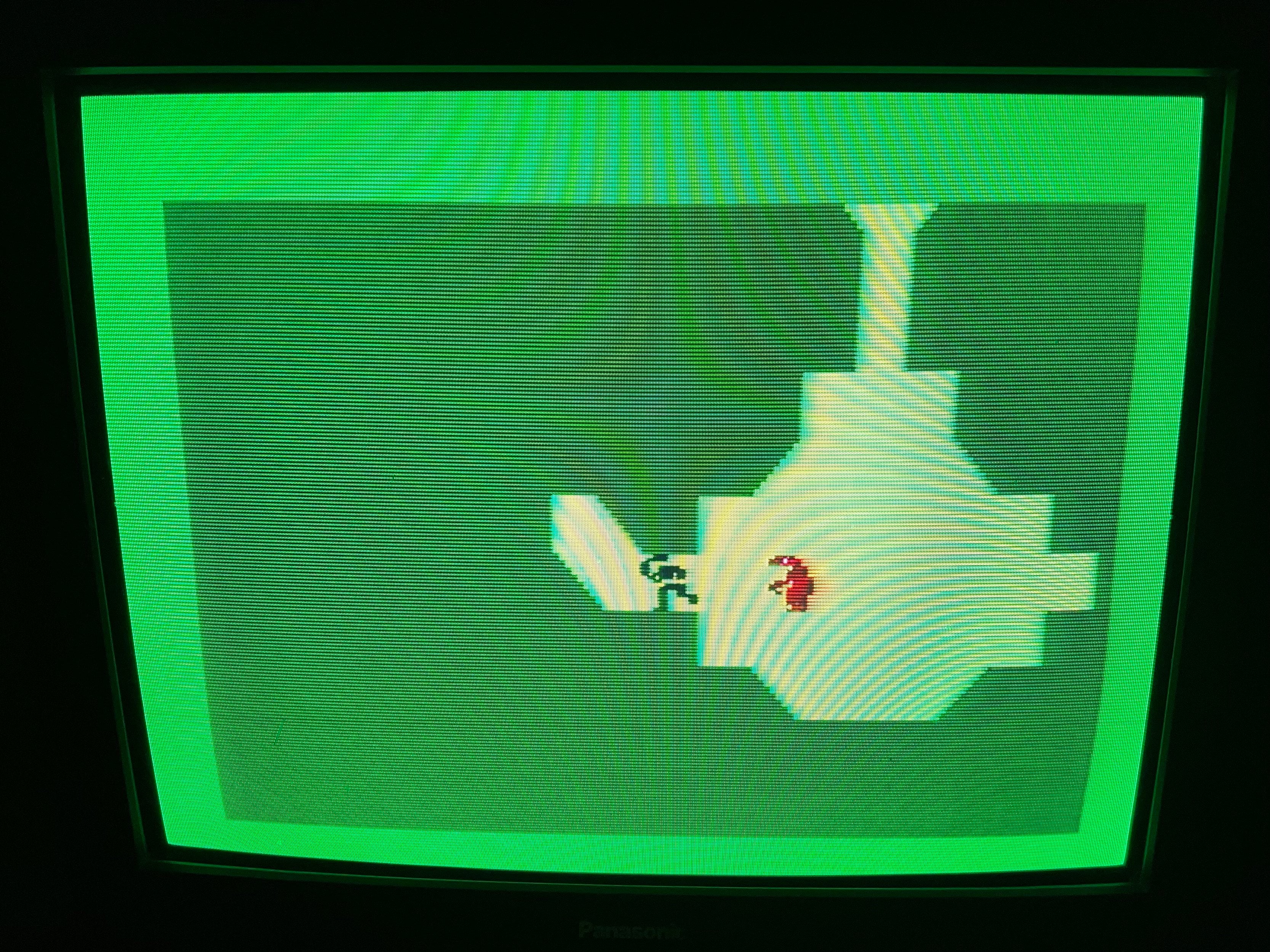 A screenshot from Advanced Dungeons &amp; Dragons, showing a small black pixel figure being pursued through a green and yellow dungeon by a red dragon.