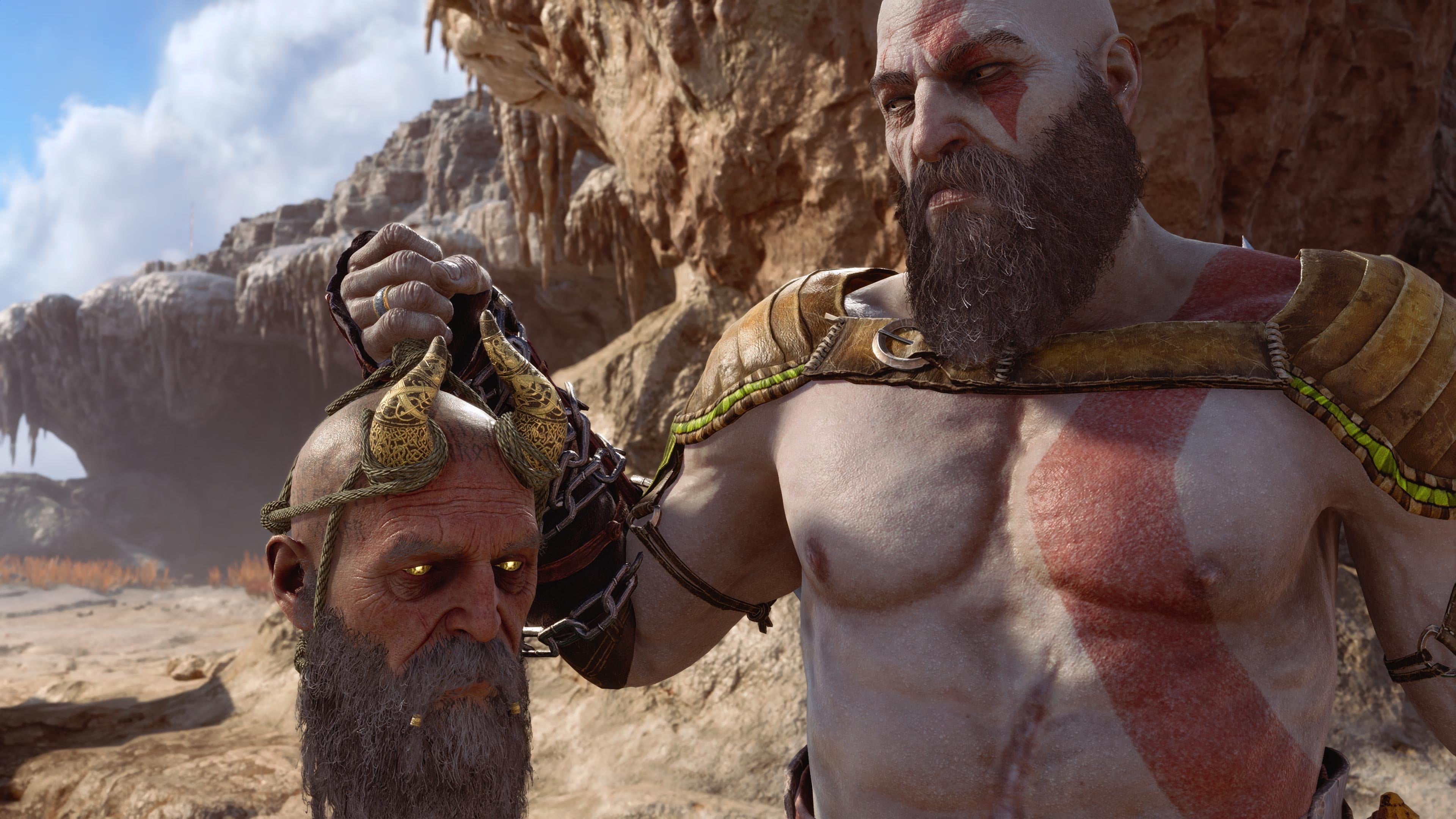 Kratos from God of War Ragnarok holds up the horned head of Mimir