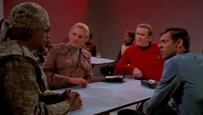Deep Space Nine still: Worf explaining TOS Klingons to his baffled colleagues