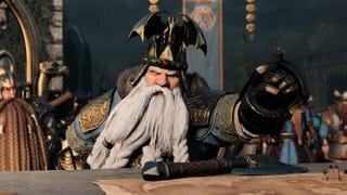 A still from the Total War Warhammer 3 Immortal Empires trailer, showing a white bearded dwarf looking very angry and pointing over a table at someone off screen