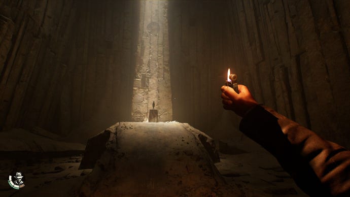 The player raises a lighter in a dark tomb and sees an idol on a plinth.
