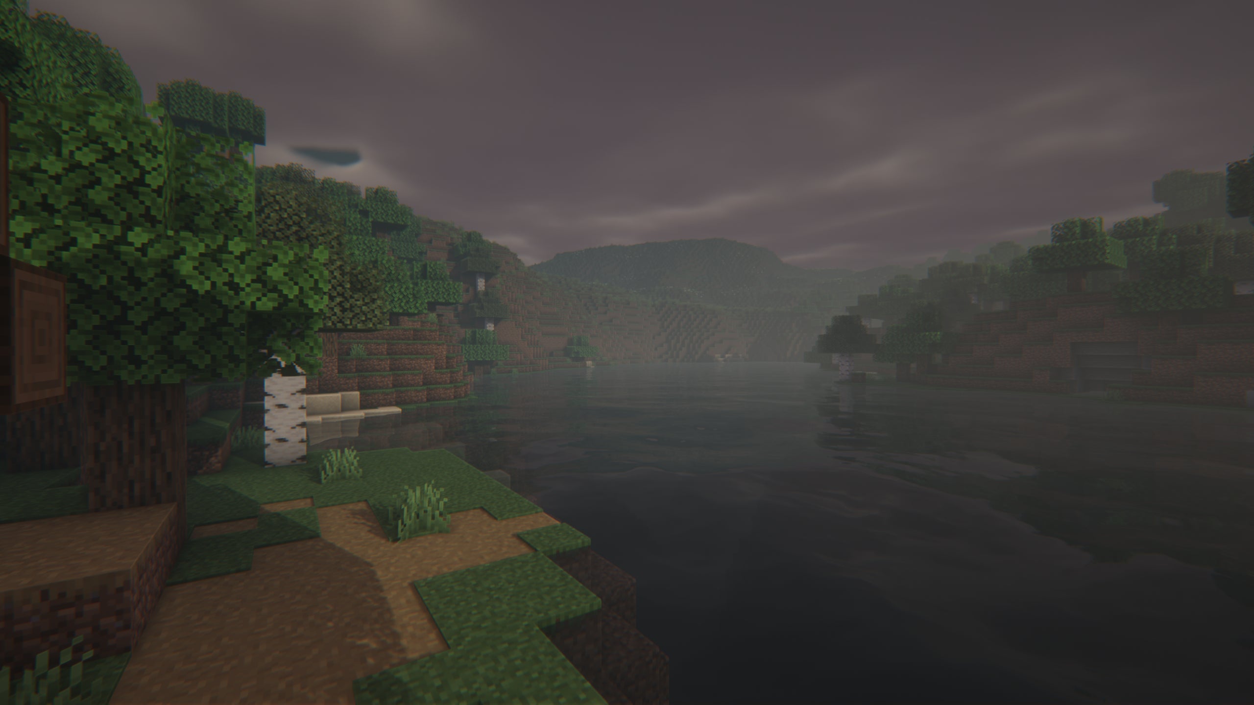 A screenshot of a river in Minecraft, with some trees on either side of the bank and a hill in the distance, taken using Insanity shaders.