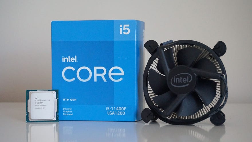 Intel’s Core i5-11400F processor next to its box and bundled cooler