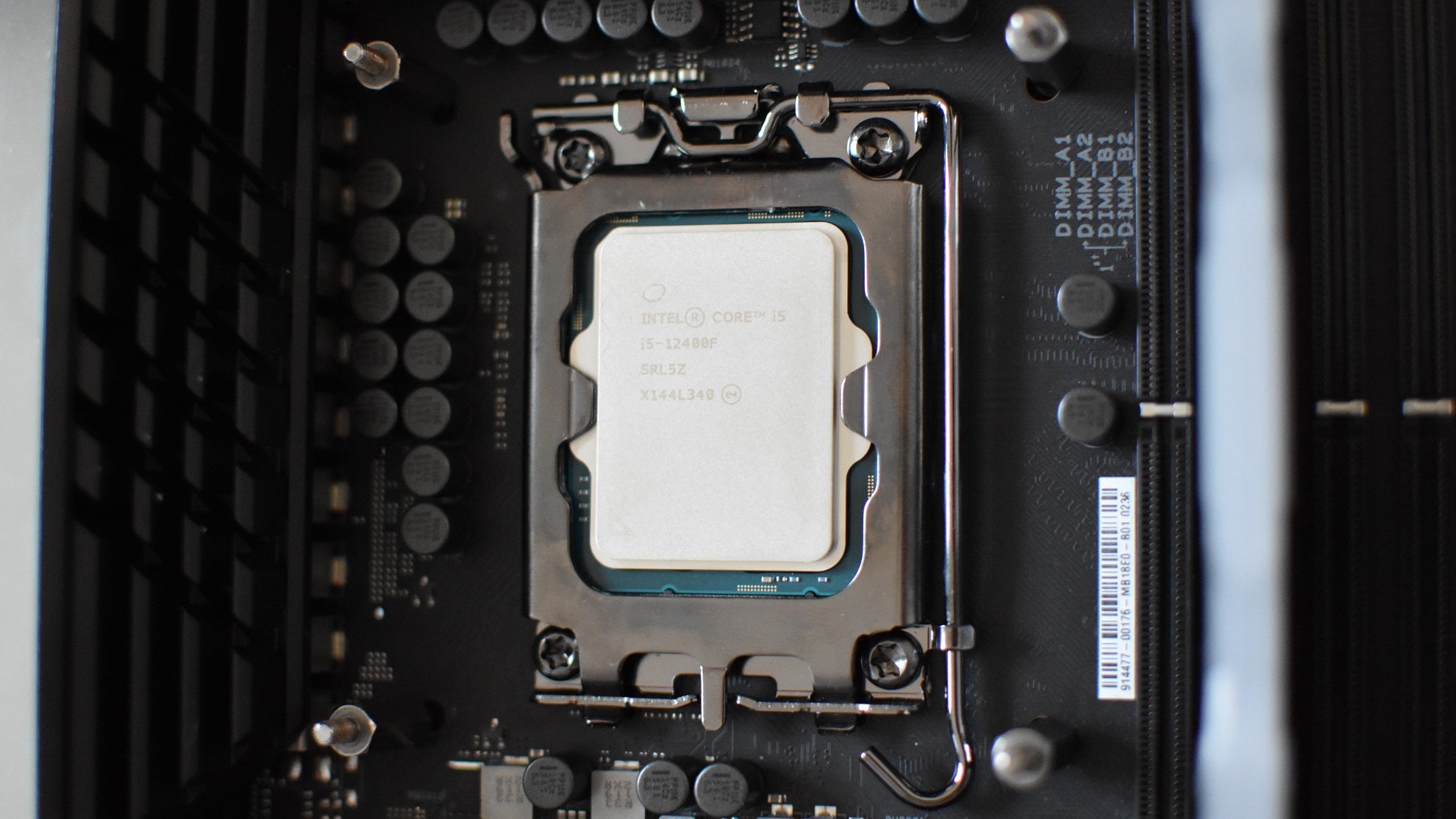 The Intel Core i5-12400F CPU installed in an LGA 1700 motherboard socket. - 1