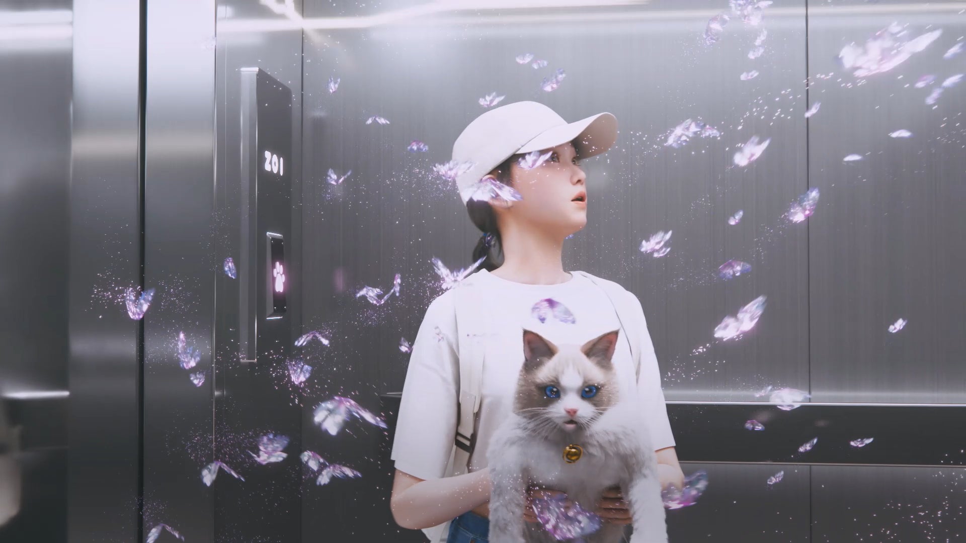 In a still from inZOI's opening cutscene, a young female character in baseball cap and t-shirt holds a befuddled-looking ragdoll cat as they ride an elevator with pink sparkling butterflies swirling around them. - 3