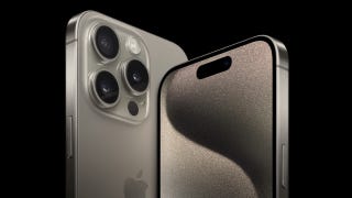 A promotional photo of the new iPhone 15 Pro. A device on the right faces forward to reveal its screen, and another on the left shows its titanium rear.
