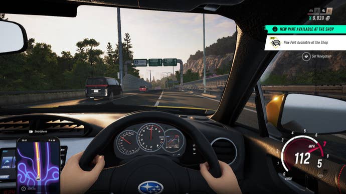 The subordinate views their car from the cockpit perspective, gripping the wheel.