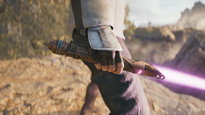 A close-up screenshot of a magenta-bladed lightsaber in Cal’s hand in Jedi: Survivor.