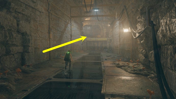 A cave passage on Koboh in Jedi: Survivor, with an arrow pointing in the direction of Vashtan Wolfe’s Lair.