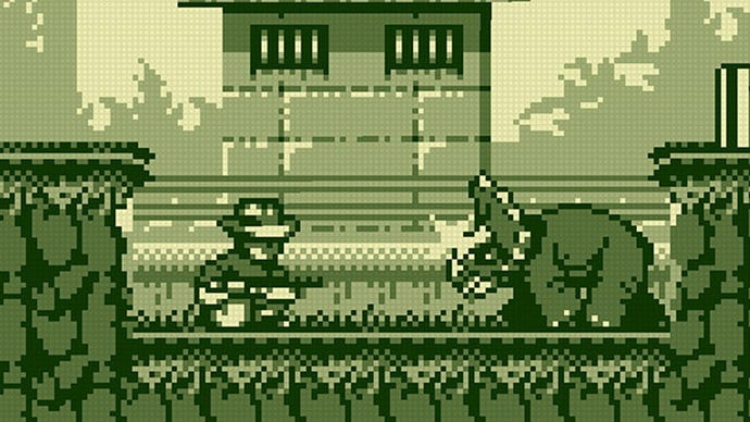 A pixelated Alan Grant faces a Triceratops in the Game Boy Jurassic Park game